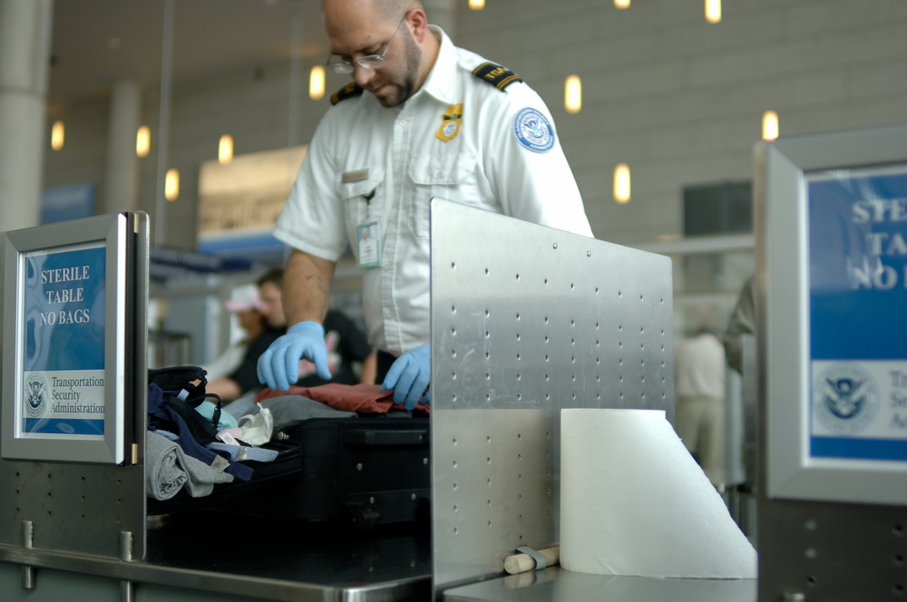 TSA agent searching luggage